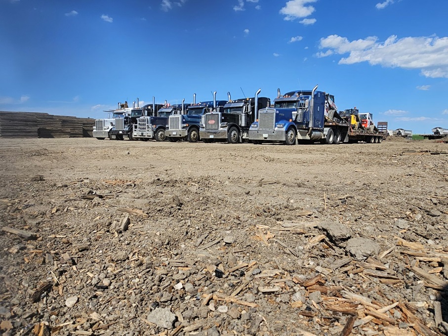 trucks lined in yard loaded with access mats and equipment